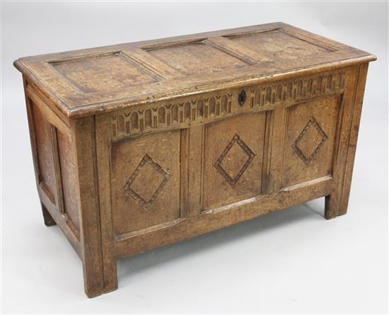 An 18th century carved oak coffer, W.3ft 9in.